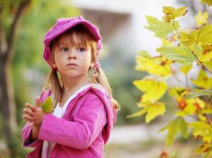 Cute little girl holding a maple leaf wallpaper thumb