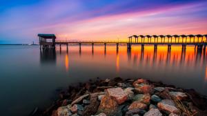 Dusk pier, rocks, water, sunset wallpaper thumb